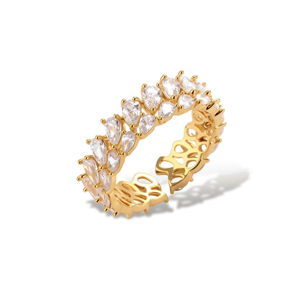 Adjustable gold-plated ring with double-row pear-shaped cubic zirconia stones in geometric pattern on cream background.
