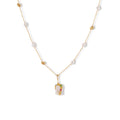 Delicate 18k gold-plated chain with baroque pearls and colorful enamel pendant featuring blue, pink accents on cream background.