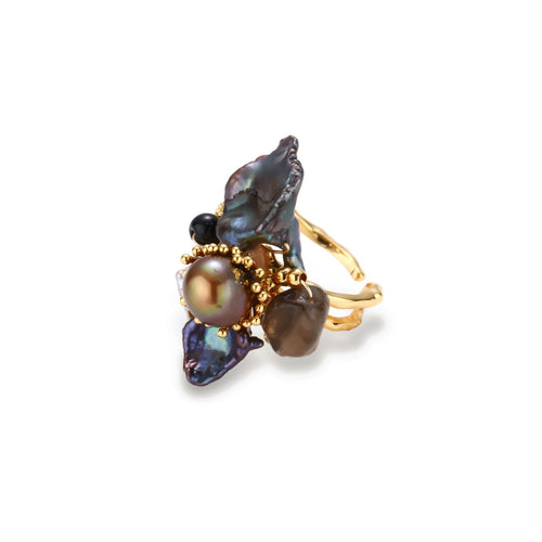 Adjustable gold-plated ring featuring clustered dark baroque pearls in organic arrangement on white background.
