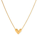Dainty 18K gold-plated sterling silver necklace with small heart pendant on delicate chain against cream background.