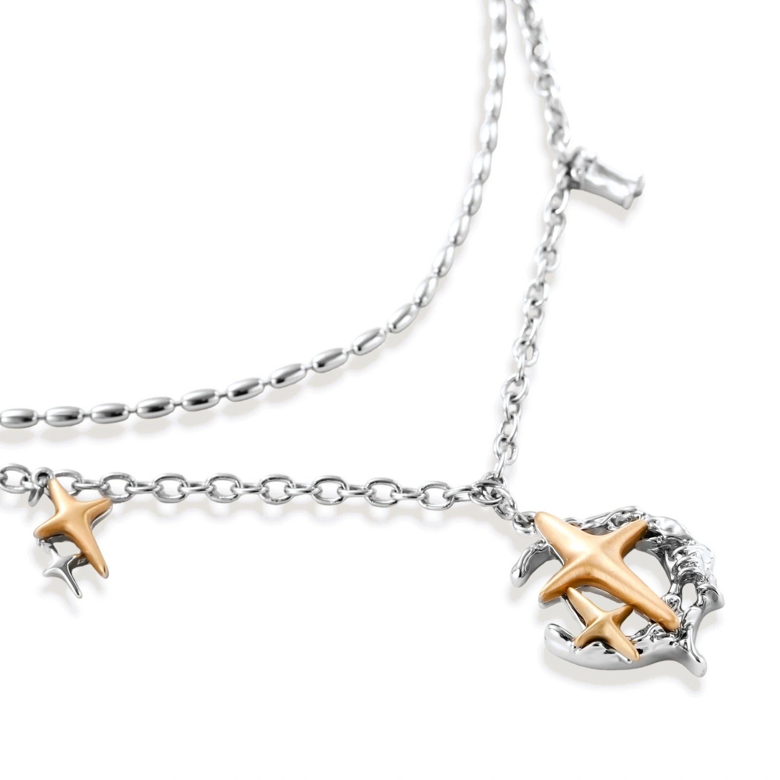 Delicate eco-brass jewelry set featuring gold star and silver moon crescents with clear zirconia crystal drops on cream background