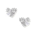 Pair of sculptural white gold-plated stud earrings with twisted ribbon design and sparkling zirconia stones on cream background