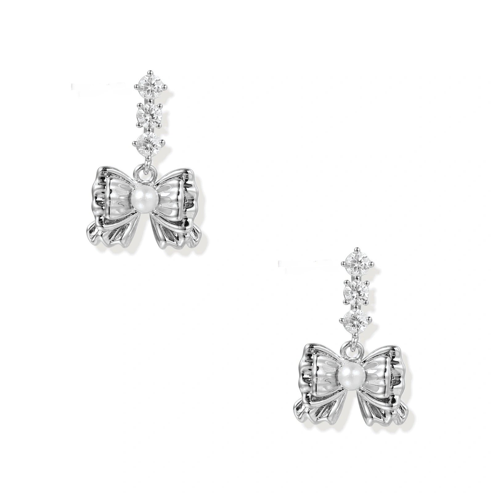White gold plated drop earrings with three graduated zirconia crystals leading to a bow charm with pearl center