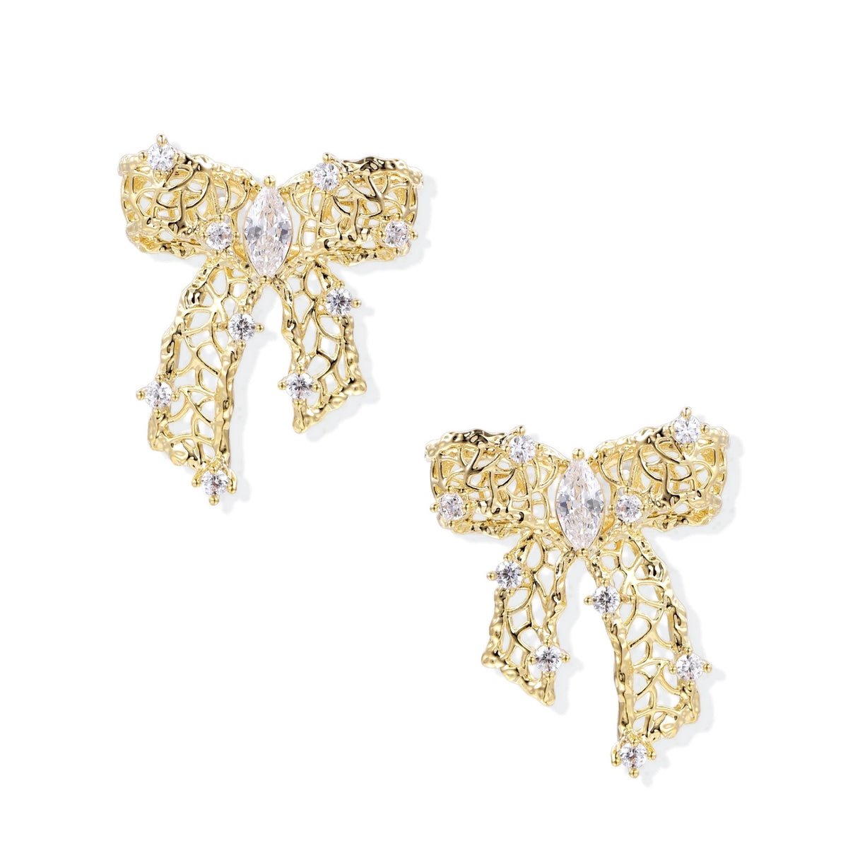 Gold-plated bow earrings with openwork design, marquise center stones, and flowing ribbon tails adorned with zirconia crystals.