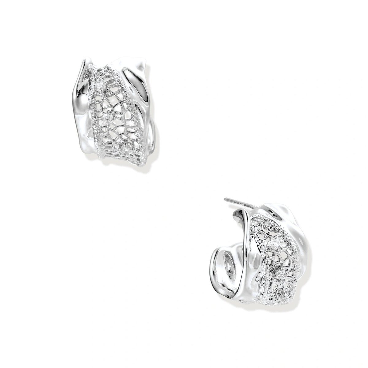 Close-up of sculptural hoop earrings with lattice center band and smooth twisted edges in white gold-plated brass with zirconia