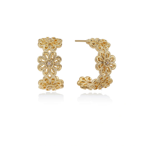 Gold hoop earrings with intricate three-dimensional floral filigree pattern in 14K gold plated brass on cream background