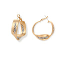 Sculptural wavy hoop earrings with crystal details and organic curved silhouette in gold and silver variants