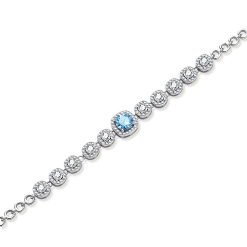Sterling silver tennis bracelet with round halo-set moissanite stones and blue center stone on cream background.