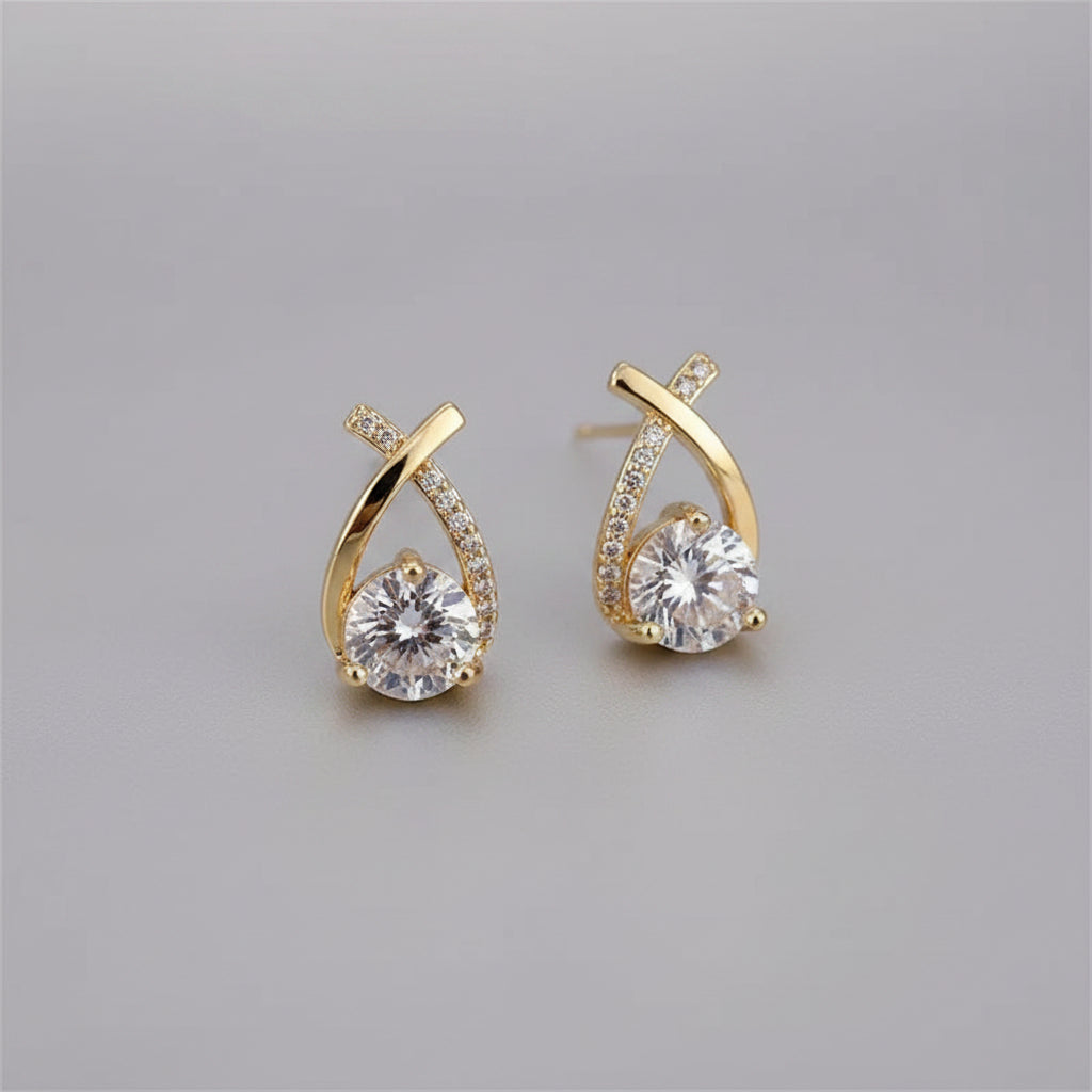 Close-up of crystal-accented cross stud earrings