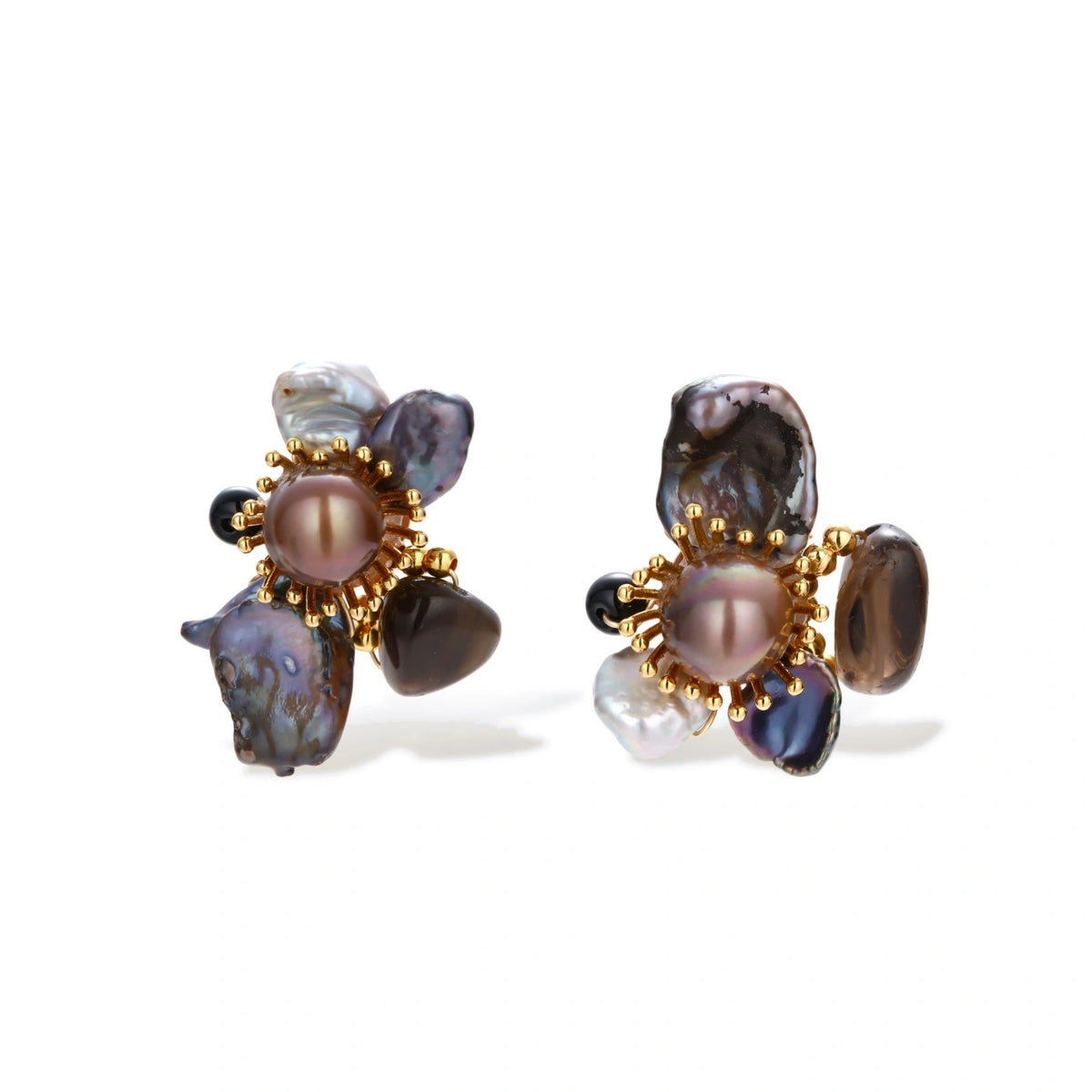 Dark baroque pearl cluster earrings with gold sunburst centers arranged in organic floral design on cream background.