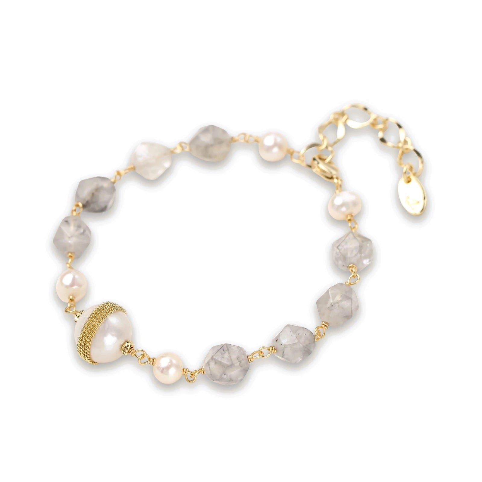 Bracelet with cloudy quartz beads, freshwater pearls, and gold-wrapped baroque pearl centerpiece on white background.