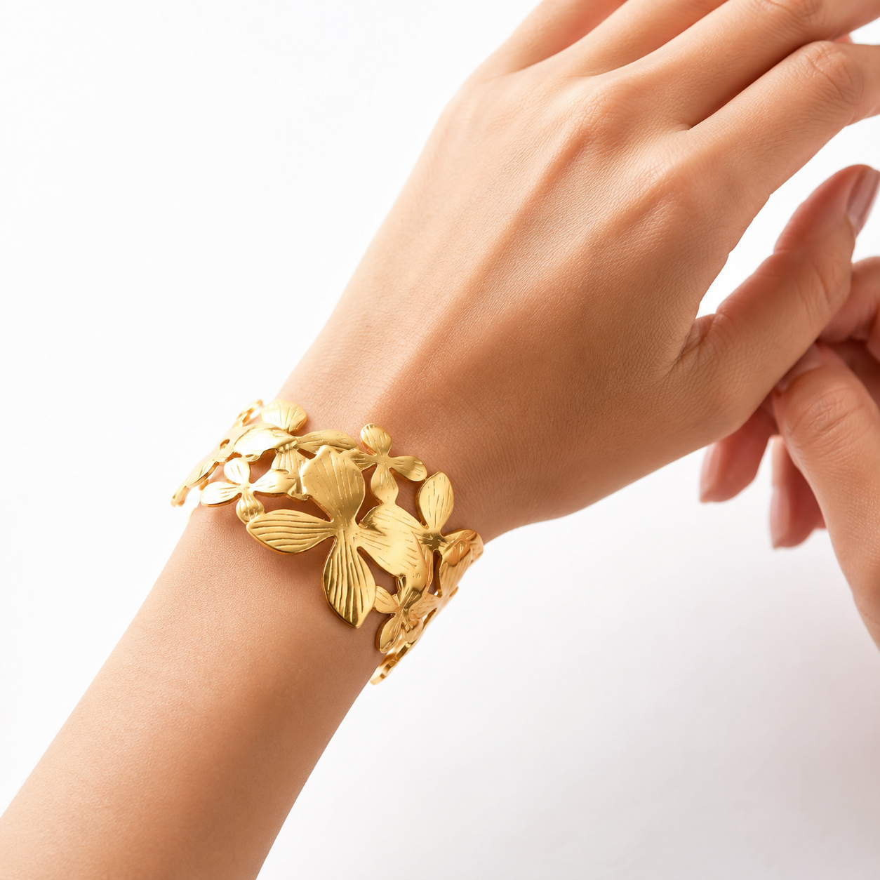 Close-up of Flora cuff bracelet with engraved flower and leaf details