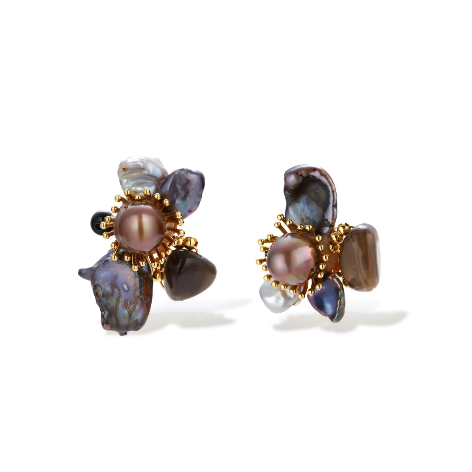 Dark baroque pearl cluster earrings with gold sunburst centers arranged in organic floral design on cream background.
