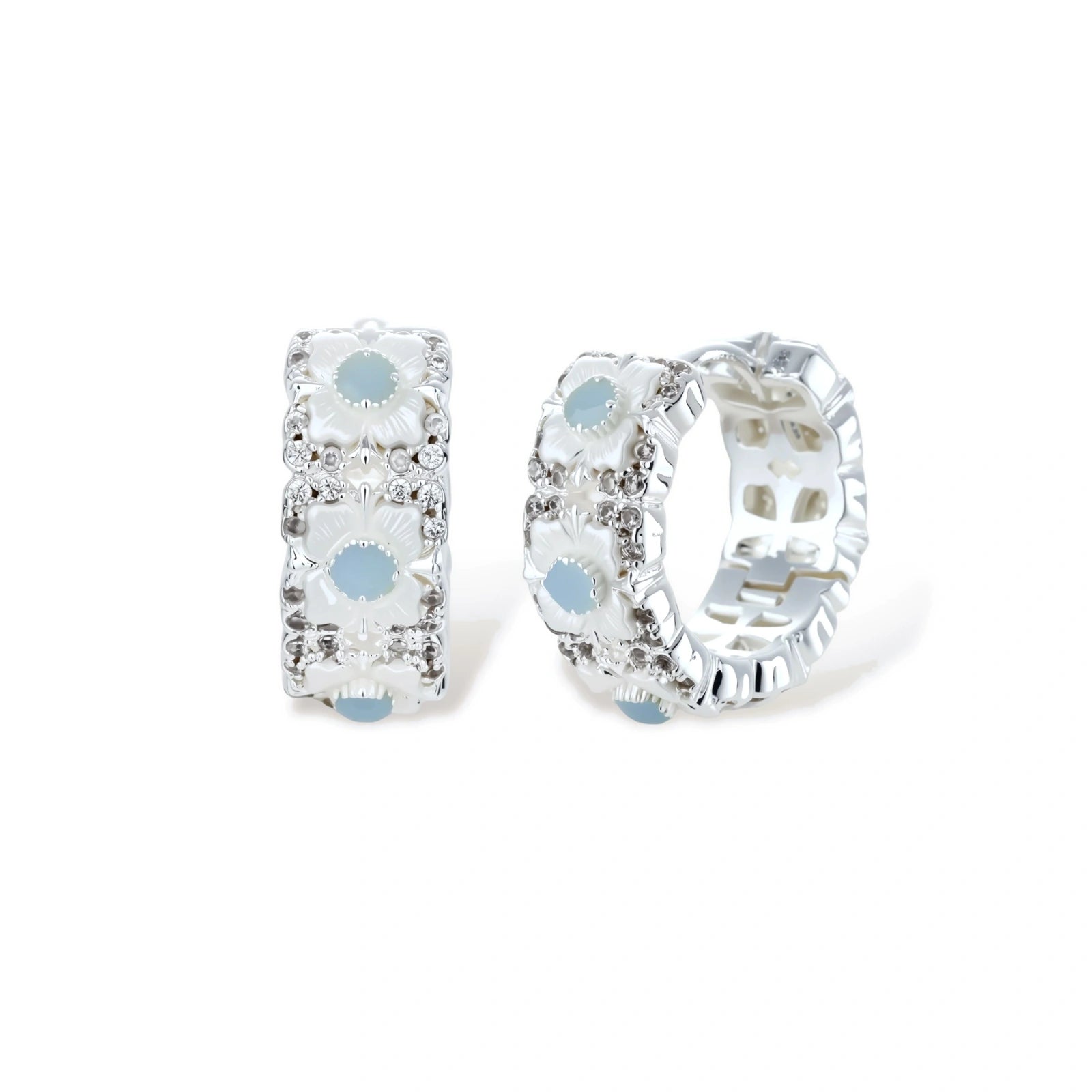 Silver-plated hoop earrings featuring delicate daisy flowers with powder blue centers and crystal accents on white background.