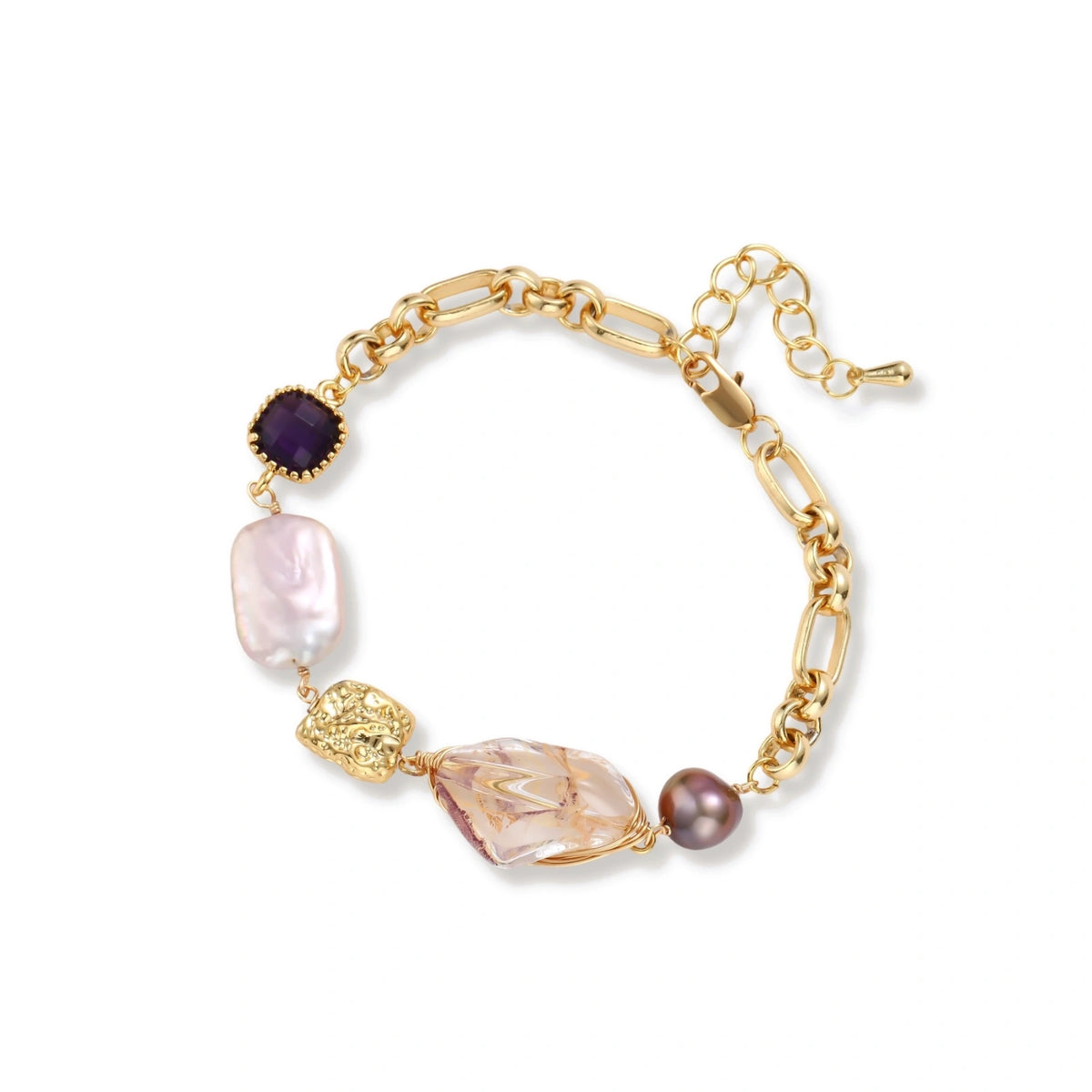 Gold-plated chain bracelet with mixed gemstones including purple stone, baroque pearl, and clear crystal on neutral background.