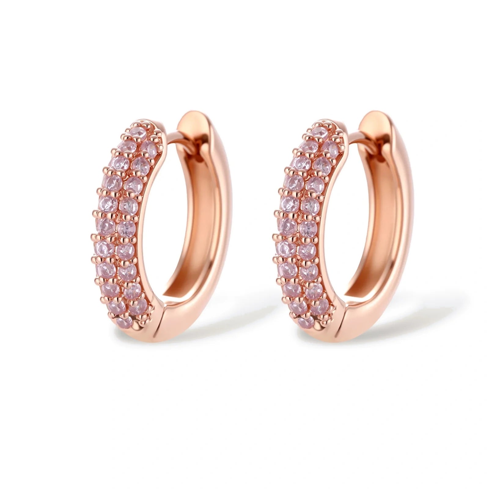 Rose gold pavé zirconia bar necklace, hoop earrings, and open ring set with pink stones on cream background.