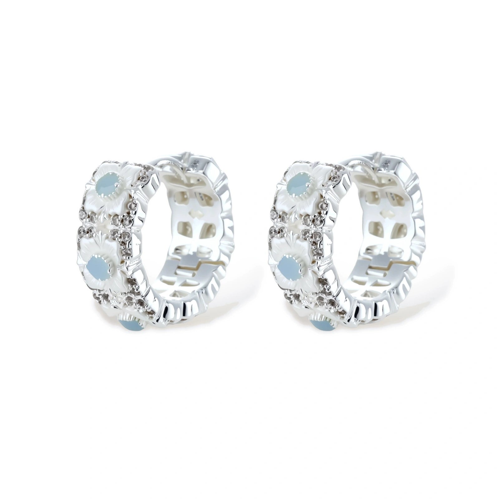 Silver-plated hoop earrings featuring delicate daisy flowers with powder blue centers and crystal accents on white background.